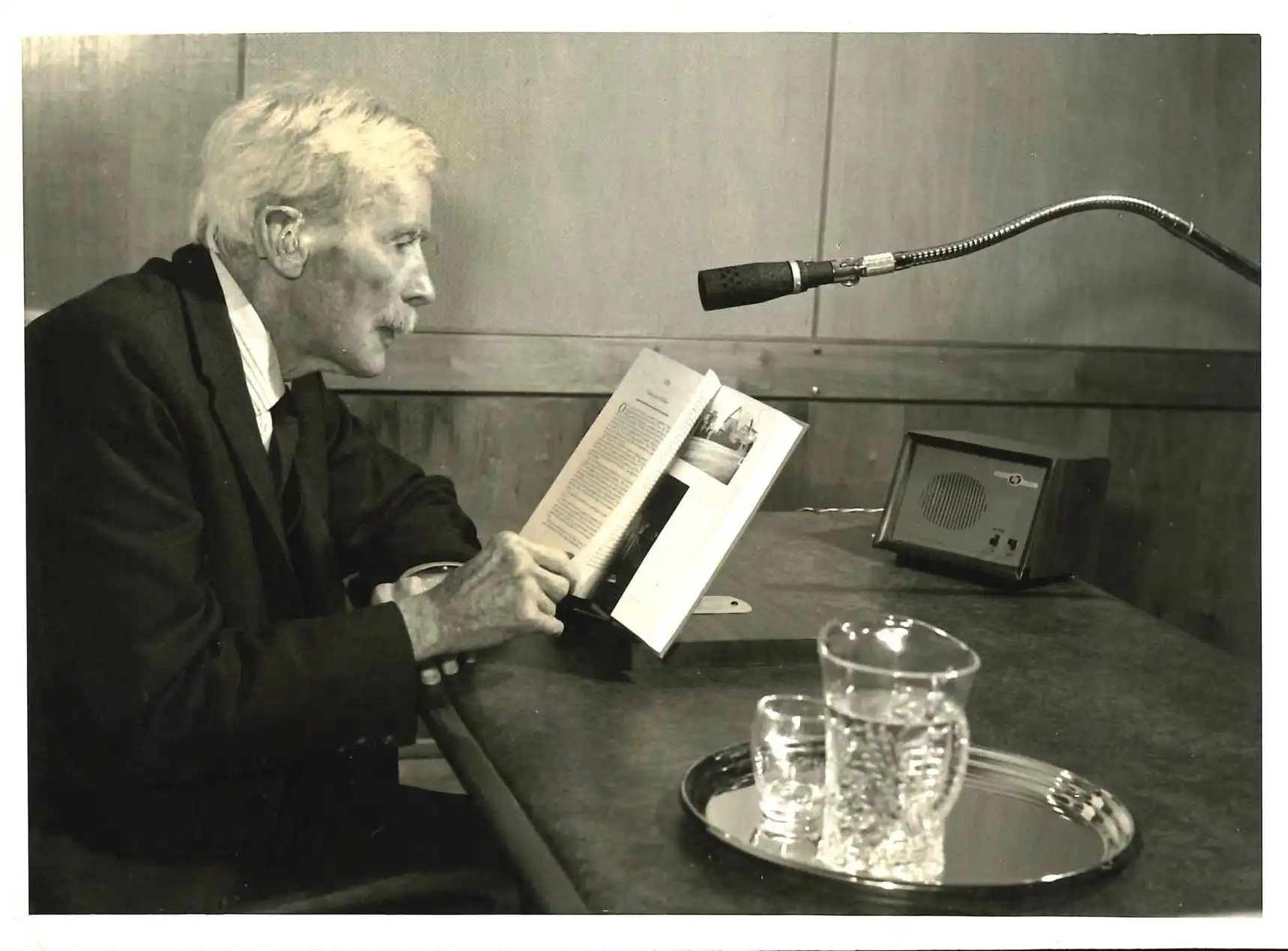 Photograph of A.H. Reed reading his Autobiography in recording studio for Foundation for the Blind, Auckland, 1968.